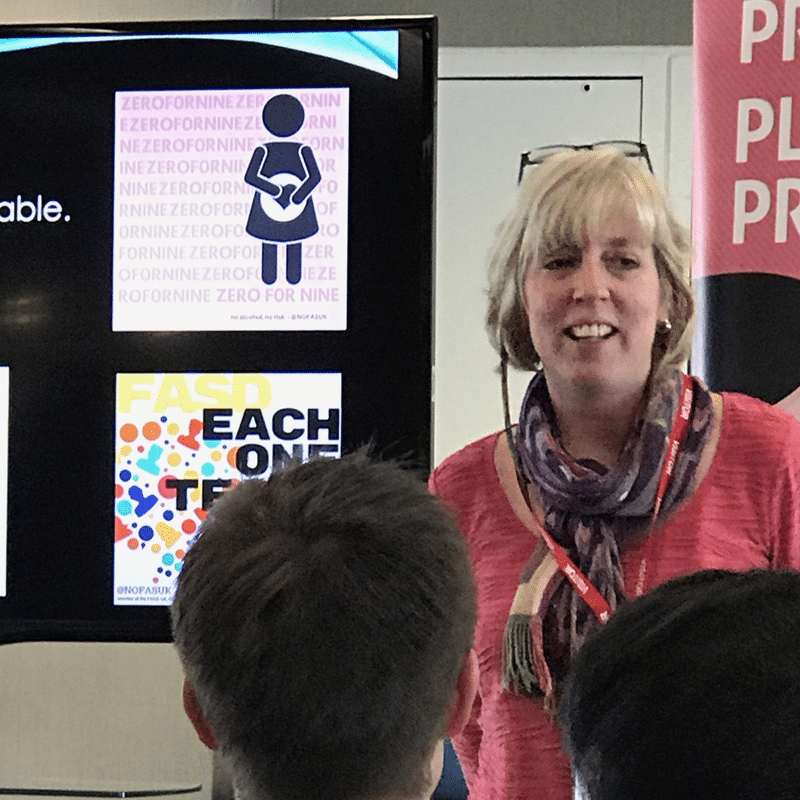Woman speaking in a crowded room