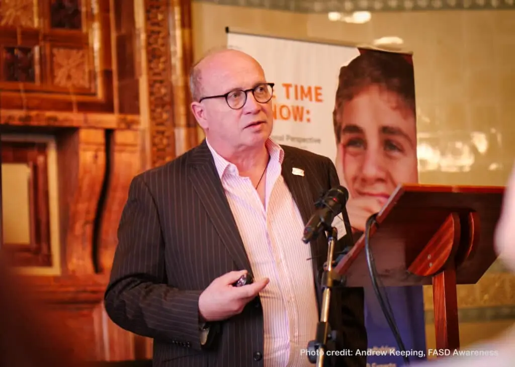 Man speaking at a podium event.