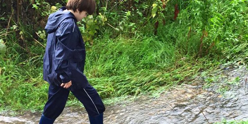 Child walking through stream